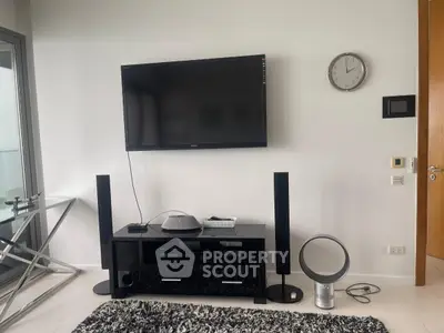 Modern living room with wall-mounted TV, sleek entertainment unit, and stylish decor.