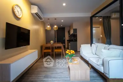 Modern living room with stylish decor and open layout, featuring a cozy seating area and dining space.