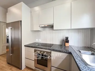 Modern kitchen with sleek appliances and granite countertops