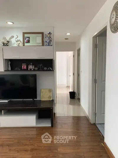 Modern living room with wooden flooring and stylish TV unit