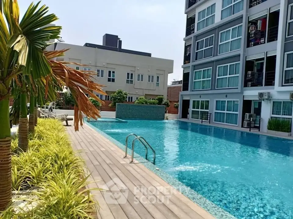 Luxurious apartment complex with stunning poolside view and modern architecture.