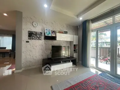 Spacious living room with modern decor and large windows for natural light