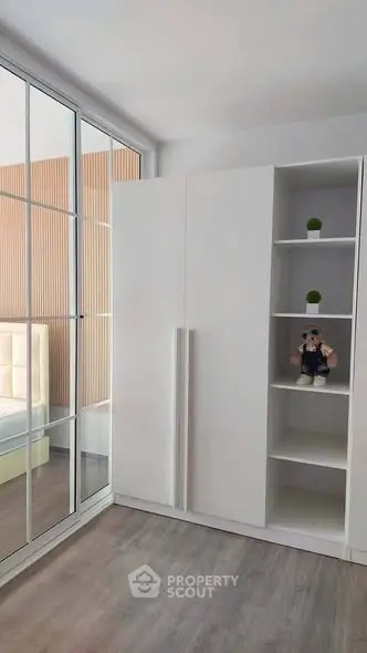 Modern bedroom with sleek white wardrobe and mirrored sliding doors