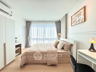Spacious modern bedroom with natural light and stylish decor, perfect for relaxation and comfort.