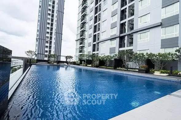 Luxurious high-rise apartment with stunning outdoor pool and modern architecture.