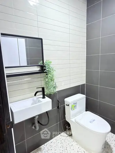 Modern bathroom with sleek fixtures and stylish tile design, perfect for contemporary living.