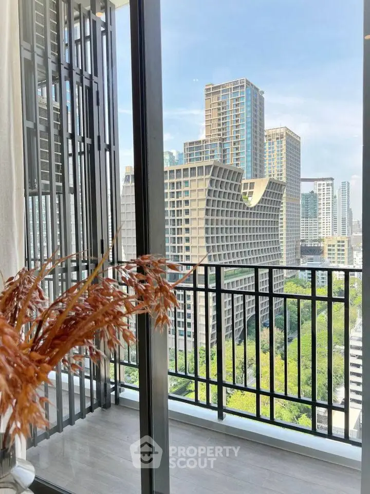 Stunning city view from modern balcony with sleek railing and lush greenery.