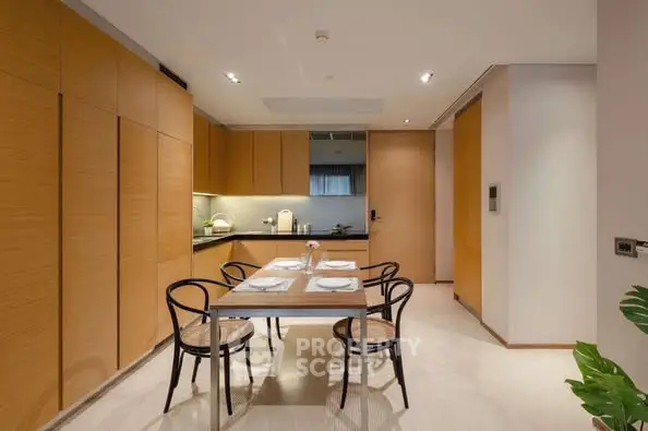 Modern kitchen with sleek wooden cabinets and dining area