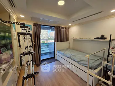 Spacious bedroom with balcony access and modern decor in urban apartment