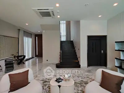 Luxurious modern living room with elegant staircase and stylish decor
