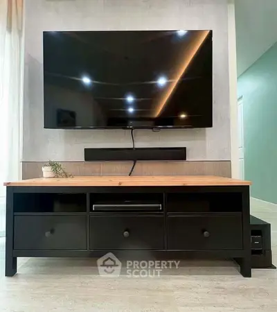 Modern living room with sleek TV setup and stylish furniture