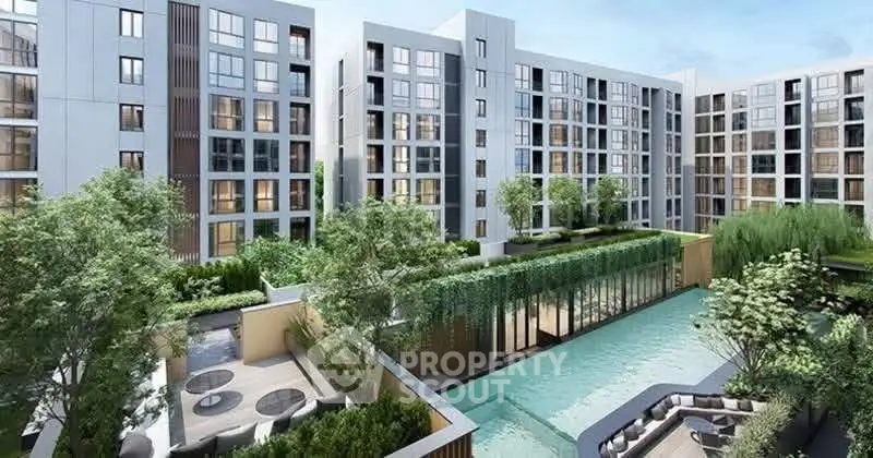Modern apartment complex with lush greenery and inviting pool area.