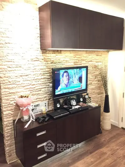 Stylish living room with modern TV setup and elegant wooden cabinets