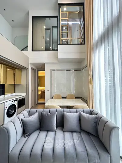 Luxurious modern living room with high ceilings and elegant decor in a stylish apartment.