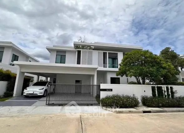 Modern two-story house with sleek design and spacious driveway