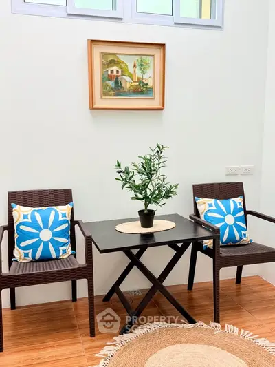 Charming interior seating area with stylish decor and vibrant cushions, perfect for relaxation and conversation.