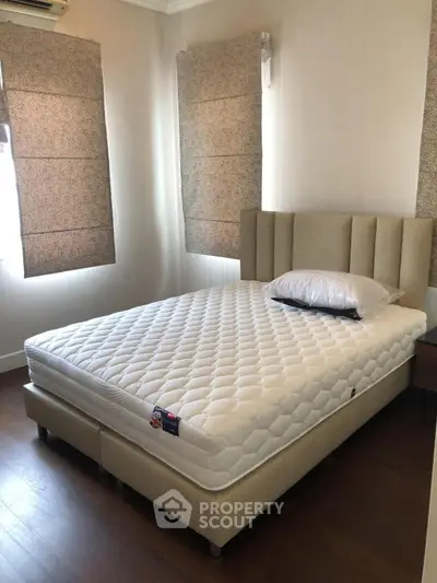 Cozy bedroom with elegant bed and stylish window treatments, perfect for restful nights.