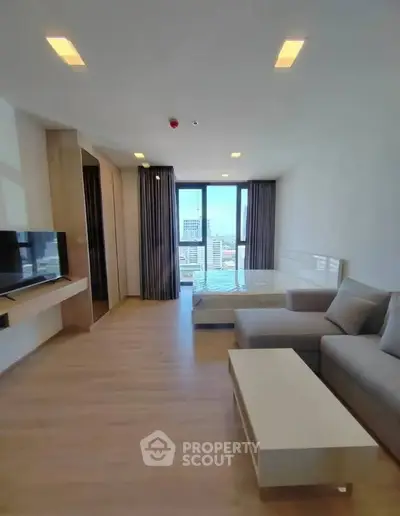 Modern studio apartment with city view, featuring sleek design and natural light.