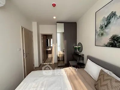 Modern bedroom with stylish decor and ensuite bathroom in a contemporary apartment.