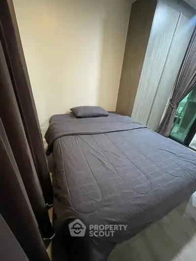 Cozy bedroom with modern decor and large window for natural light