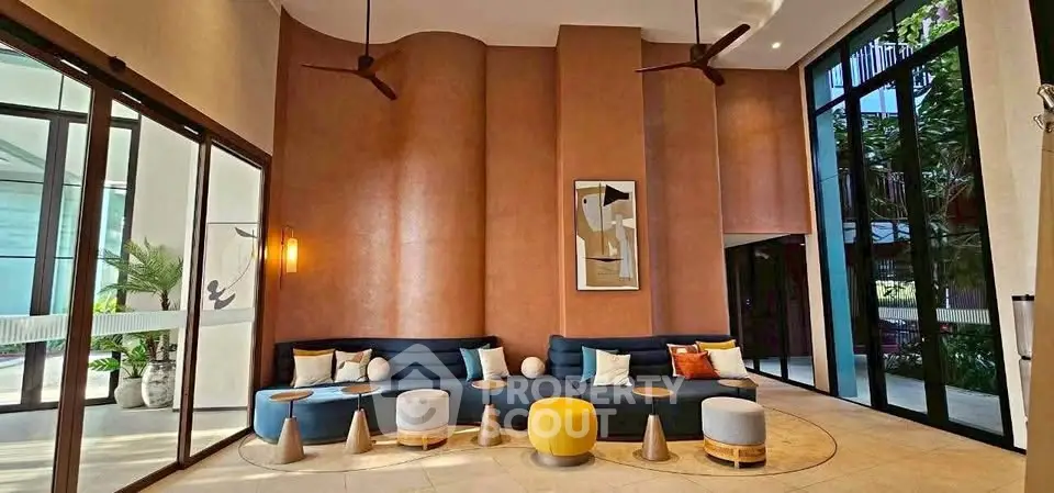 Luxurious modern lobby with stylish seating and elegant decor, perfect for welcoming guests in a high-end building.