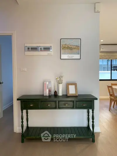 Charming interior with elegant green console table and stylish decor, perfect for modern living spaces.