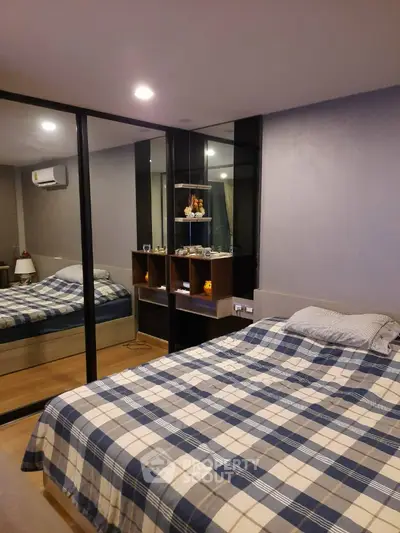 Modern bedroom with mirrored wardrobe and cozy bedding
