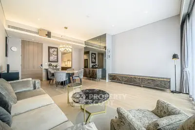 Luxurious modern living room with elegant decor and ample natural light.