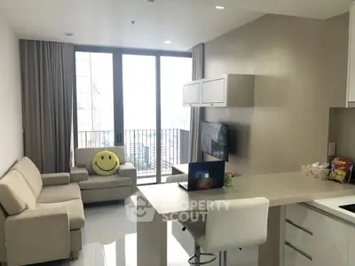 Modern living room with balcony view and sleek kitchen design
