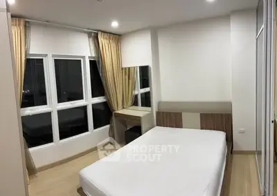 Modern bedroom with large windows and neutral decor