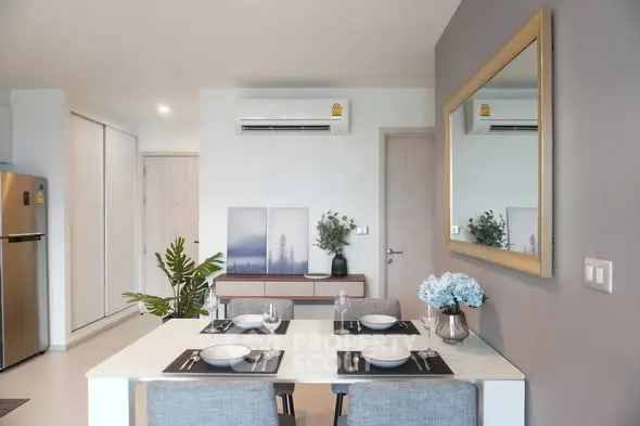 Modern dining area with stylish decor and air conditioning in a contemporary apartment.