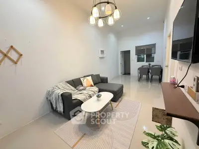 Modern living room with stylish sofa and elegant lighting in a cozy apartment.