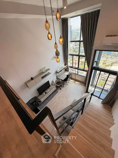 Modern loft apartment with high ceilings and large windows offering stunning city views.