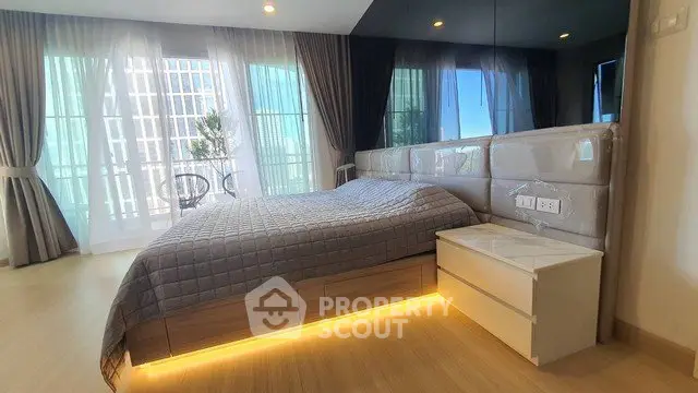 Luxurious bedroom with modern design and large windows offering natural light.