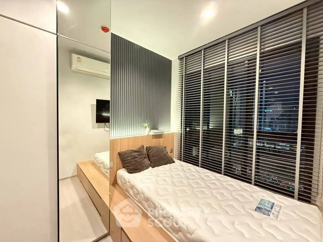 Modern bedroom with city view, sleek design, and cozy ambiance.