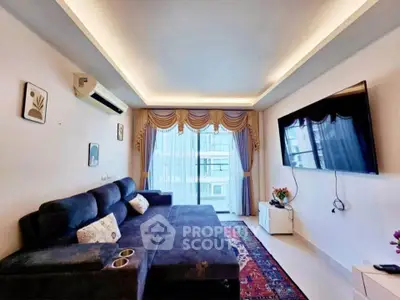 Spacious living room with modern decor and large TV, perfect for relaxation.