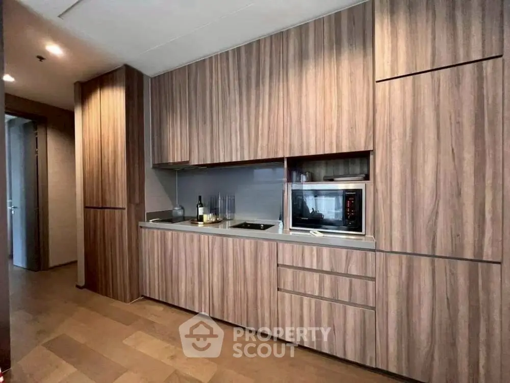 Modern kitchen with sleek wooden cabinetry and built-in appliances