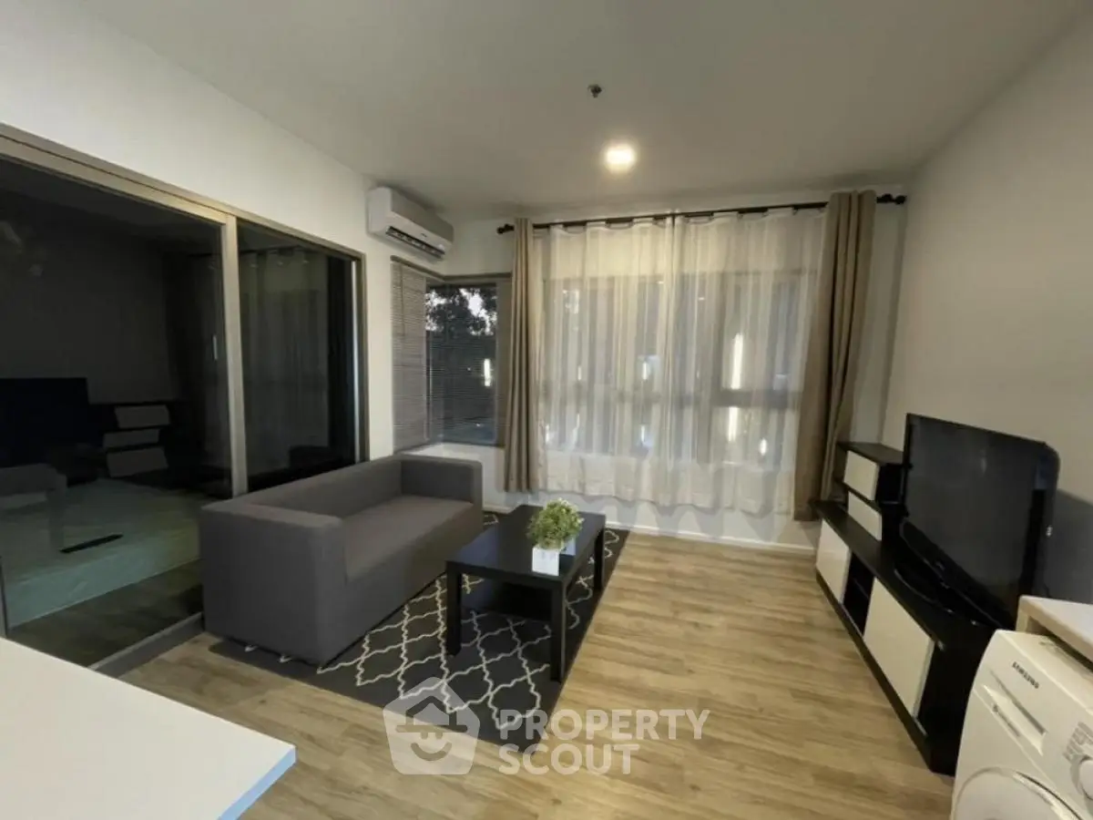 Modern living room with stylish furniture and large windows for natural light.