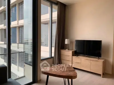 Modern living room with large windows and stylish furniture in a high-rise apartment.