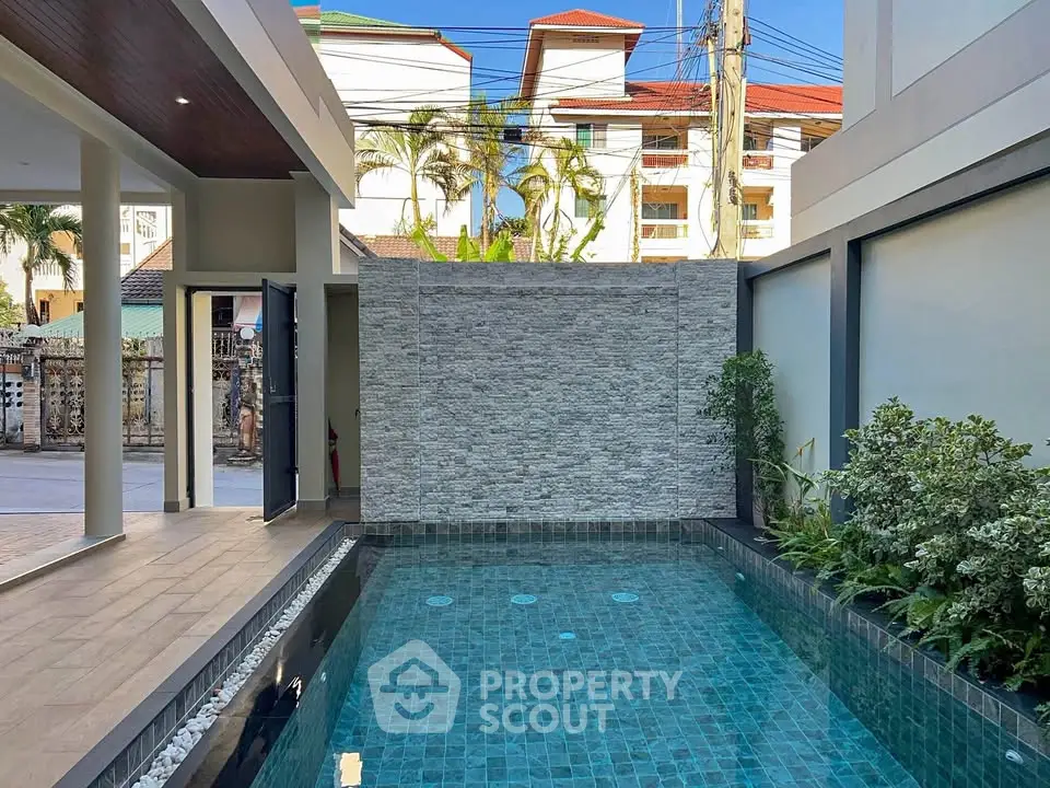 Luxurious private pool area with modern design and lush greenery, perfect for relaxation and entertainment.