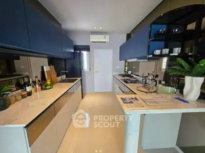 Modern kitchen with sleek cabinetry and marble countertops in a stylish apartment.