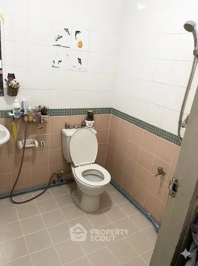 Cozy bathroom with tiled walls and modern fixtures, perfect for a compact living space.