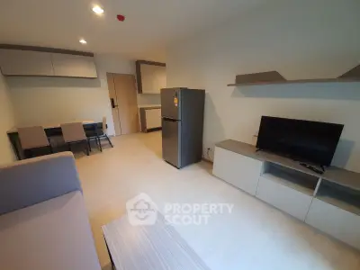 Modern living room with sleek furniture and appliances in a stylish apartment.