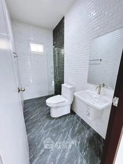 Modern bathroom with sleek tiles and glass shower enclosure