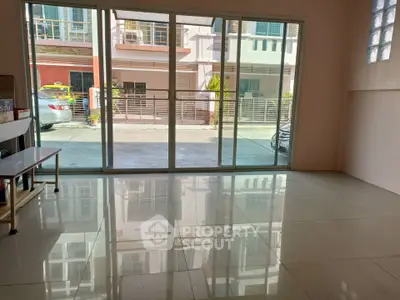 Spacious room with large windows offering ample natural light and street view.