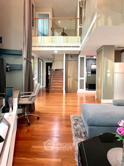 Luxurious duplex living room with modern decor and wooden flooring