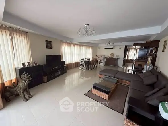 Spacious modern living room with elegant decor and ample natural light.