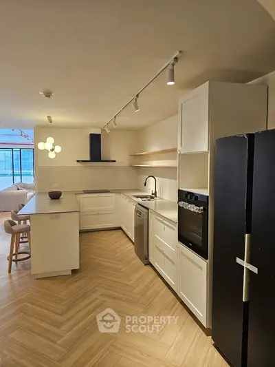 Modern kitchen with sleek appliances and open layout in a stylish apartment.