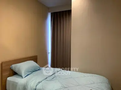 Cozy bedroom with single bed and soft lighting, perfect for restful nights.