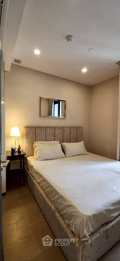 Cozy bedroom with plush bed and ambient lighting in modern apartment